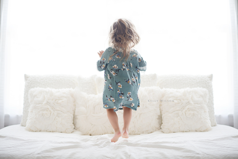 girl jumping on bed window photos Kelly Wilson Photography